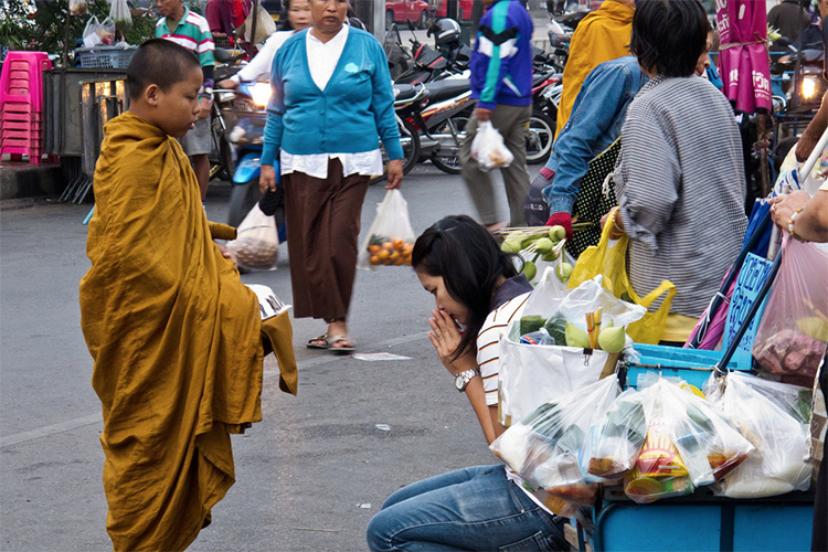 Early morning alms giving to monks tour